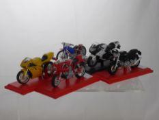 A Collection of Ten 1:18th Scale Die Cast Motorcycles, the bikes supported on plinths,