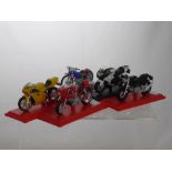A Collection of Ten 1:18th Scale Die Cast Motorcycles, the bikes supported on plinths,