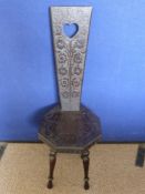 A Welsh Loving Seat, decorative carving to the back and seat.