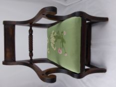 An Antique Mahogany Regency child's dining chair. The chair having a floral embroidered seat.