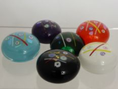 Six Caithness Glass Paperweights, including 'Noughts and Crosses', purple, white, red, green,