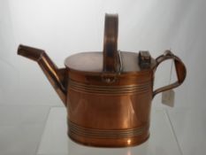 A Copper Hot Water Can, (from the Edwardian period) together with a brass tea pot with vaseline