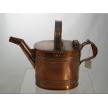 A Copper Hot Water Can, (from the Edwardian period) together with a brass tea pot with vaseline