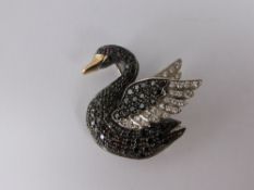 An 18ct Black and White Diamond Swan Brooch, set ruby eye black pave set diamond body with white