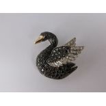 An 18ct Black and White Diamond Swan Brooch, set ruby eye black pave set diamond body with white