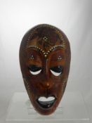 A Decorative South Sea Style Tribal Mask inlaid with Mother of Pearl.