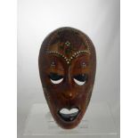 A Decorative South Sea Style Tribal Mask inlaid with Mother of Pearl.