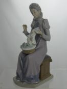 A Lladro Figure of an Elizabethan Style Woman Sewing, impressed marks to base C - 17 D 30 cms high.