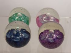 Four Caithness Glass Paper Weights, including 'Summer Fruit' in blue, green, pink and mauve.