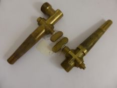 A Pair of Brass Beer Barrel Taps one unmarked and the other bearing a cross.