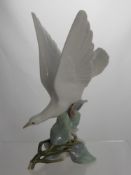 A Lladro Figure of a Dove, impressed marks to base D - 28 - 2, 29 cms high.