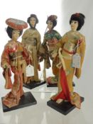 Four Japanese Figures, supported on ebonized plinths, depicting Geisha.