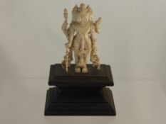 An Antique Indian Carved Ivory Figure, depicting a Goddess. Approx 11 cm high on carved wooden