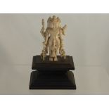 An Antique Indian Carved Ivory Figure, depicting a Goddess. Approx 11 cm high on carved wooden