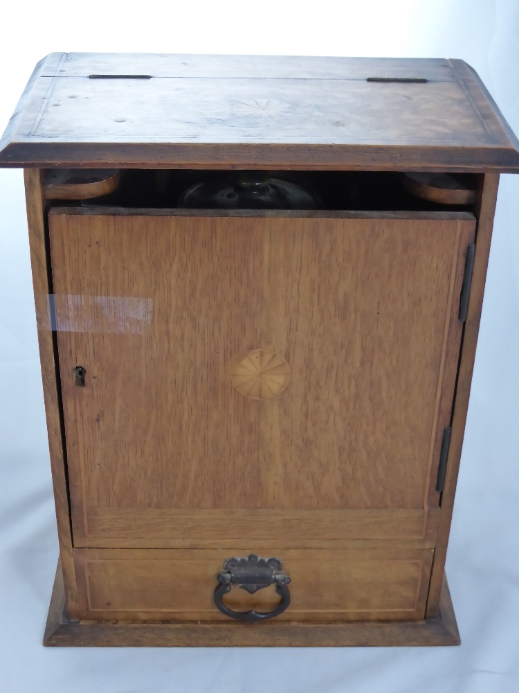 An Oak Tobacco Cabinet, with the original Royal Doulton tobacco pot, fitted interior and a single