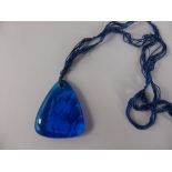 A 1920's Lalique Blue Glass Pendant, the triangular pendant depicting fruit and signed LALIQUE