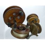 Four Vintage Wooden Fishing Reels, including an Eton Sun and three others unmarked.
