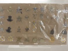 A Carded Display of Military Cap Badges,  mostly relating to the brigade of Gurkha 1/11th battalions