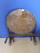 A Chinese Hand Carved Tilt Top Table, the circular table having frieze depicting pagodas, sailing