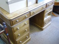 A Vintage Twin Pedestal Pine Desk, the desk having an inlaid top with central drawer and four
