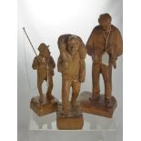 A Miscellaneous Collection of Figurines, including four hand carved wooden figures depicting various