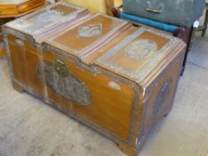 A Vintage Chinese Camphor Wood Travel Chest, the chest carved with various panels depicting junks on