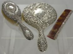 A Circa 1900 Solid Silver Part Dressing Table Set, including hand mirror, the mirror embossed with