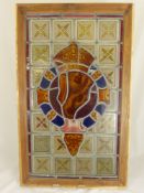 A Stained Glass Window depicting a Regimental Insignia, approx 35 x 63 cms, framed.