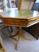 A Reproduction Yew Wood Leather Top Drum Table, 61 cms high x 58 cms.