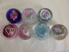 Seven Caithness Glass Paper Weights representing a wedding scene, two "Eternity" blue/pink, "Wedding