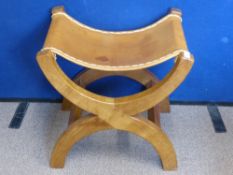 A Robert "Mouseman" Thompson of Kilburn Oak X Frame Stool, the stool having a tanned hide seat