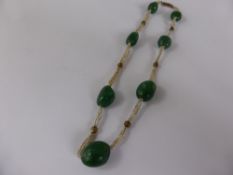 An Antique Green Stone and Seed Pearl Necklet, on gold barrel clasp.
