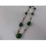 An Antique Green Stone and Seed Pearl Necklet, on gold barrel clasp.