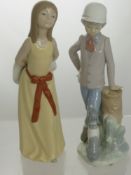 A Lladro Figure of a Young Girl, No. 5006 together with another figure of a young boy with a dog.