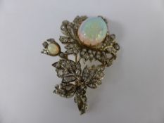 An Antique Opal and Diamond Brooch. The brooch in the form of a flower set with two opals and old