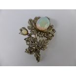 An Antique Opal and Diamond Brooch. The brooch in the form of a flower set with two opals and old