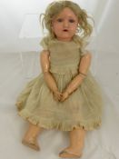 A Heinrich Handwerck Porcelain Headed Doll, stamped H W Germany 6.1/2, the doll with sleeping