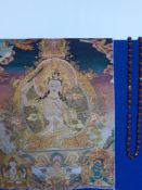 A Chinese Hand Embroidered Tanka depicting Buddha 58 x 78 cms together with a nut necklace 150 cms