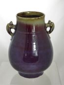 A Chinese Sangeboeuf purple and celadine green vase, the vase having shell form handles, 29 cms