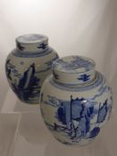 A Pair of Chinese Blue and White Ginger Jars with lids, double circle ring mark to base, 18 cms