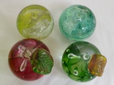 Four Caithness Glass Paper Weights, two in the form of an apple with glass leaves, one pink and