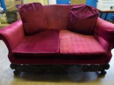 A Chippendale style oak framed three piece suite comprising a two seater sofa and two chairs, all