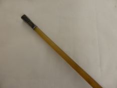 An Antique Rhino Horn Swagger Stick, the stick having a silver cap depicting bamboo, 78 cms long,