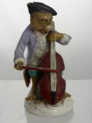 A Continental Porcelain Monkey, depicted playing a cello, with blue crossed mark to the base, approx