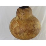 An African Gourd (possibly a camel bladder) together with a large earthenware jug, 37 cms high.