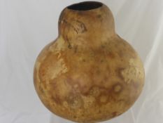 An African Gourd (possibly a camel bladder) together with a large earthenware jug, 37 cms high.