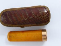 A Gold and Amber Cigarette Holder, marked 375, presented in a snake skin box.