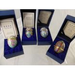 Four Halcyon Days Enamel Easter Eggs including years 2000, 2001, 2002 and 2004, in the original