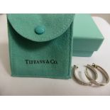 A Pair of Tiffany & Co., C2003 925 Hallmark Hoop Earrings, the earrings in original suede pouch with