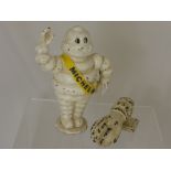 A Cast Iron Michelin Man Piggy Bank, 22 cms high, together with a cast iron door knocker in the form